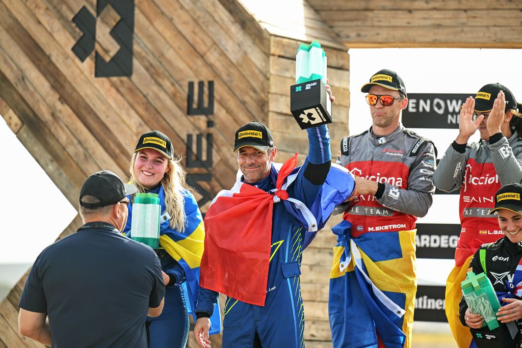 CAPO TEULADA, SARDINIA, ITALY - SEPTEMBER 16: Klara Andersson (SWE) / Sebastian Loeb (FRA), Abt Cupra XE, 2nd position, receive their trophies on the podium during the Island X-Prix II on September 16, 2023 in Capo Teulada, Sardinia, Italy. (Photo by Simon Galloway / LAT Images)